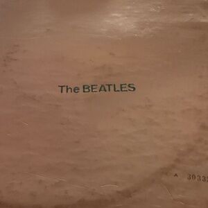 The Beatles Black Text on Tan Surface